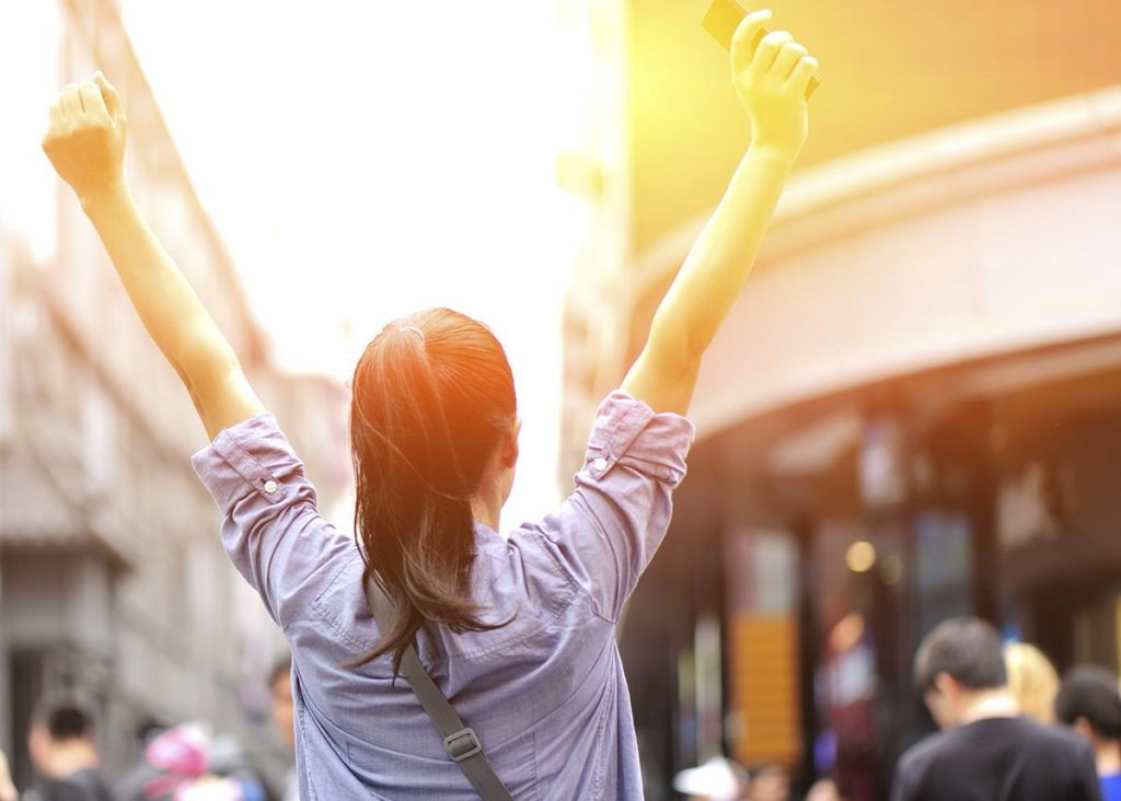 Girl raising her hand for Success