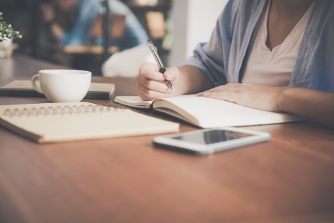 Person writing in a notebook