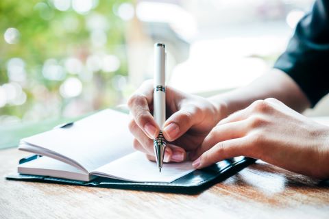 Person writing in journal